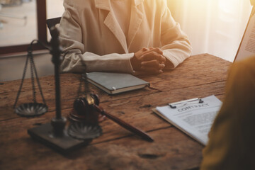 Judge gavel with Justice lawyers having team meeting at law firm background. Concepts of Law and Legal services.