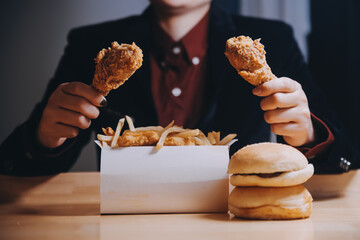 close up focus woman hand hold fried chicken for eat,girl with fast food concept