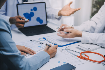 Meeting, tablet and team of doctors with collaboration for healthcare talk and telehealth app in office. Surgeon group, tech and medical discussion with website for hospital funding or sponsorship