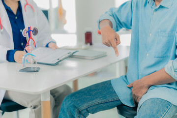 A young man goes to the doctor for a checkup for his health, sexual performance, and prostate cancer. The doctor then examines his penis for a tumor. Close-up. © MrAshi