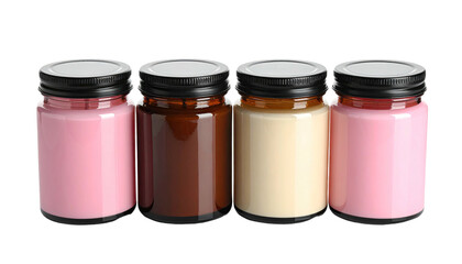 Row of colored wax candles in glass jars with black lids against black