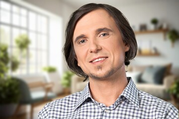 Happy confident man standing at home.