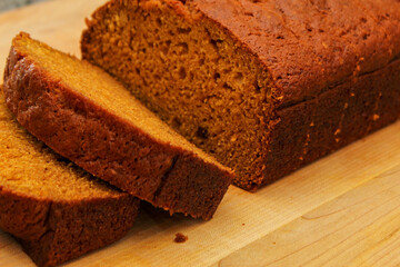 Fresh Homemade Pumpkin Bread Sliced on Wooden Cutting Board