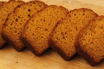 Fresh Homemade Pumpkin Bread Sliced on Wooden Cutting Board