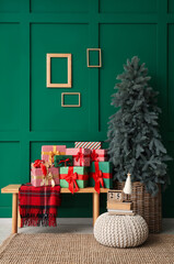 Interior of living room with Christmas tree and presents on bench