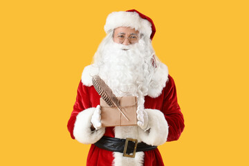 Santa Claus with letters on yellow background