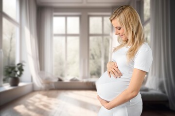 Pregnant young  woman holds belly with her baby
