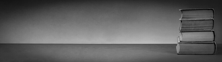 Stack of Vintage Books on a Subdued Gray Background