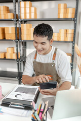 Ecommerce startup business model with entrepreneur preparing goods for delivery, symbolizing...