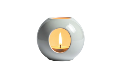 Spherical ceramic oil burner with tea light, glowing on black