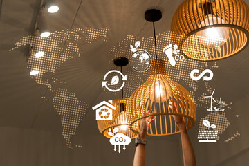 Sustainable energy concept with hands adjusting eco light bulb and global recycling environment...