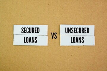 Papers with the words Secured vs Unsecured Loans. Business loan concept. Secured Loans offer lower...