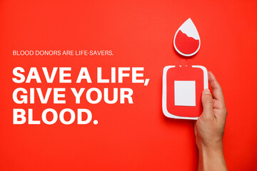 Hand holding a paper blood bag with a red background