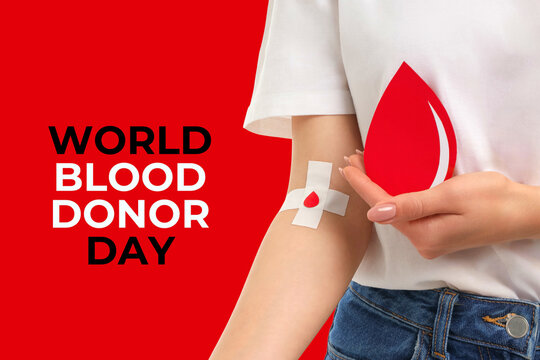 A person holds a red blood drop symbol beside a bandaged arm