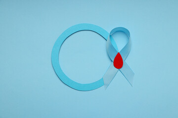 Blue circle with a light blue ribbon featuring a red drop