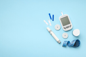 Naklejka na ściany i meble Glucometer and insulin pen on a blue background