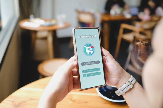 A person holding a smartphone, about to checkout on an online shopping app. The screen shows one item in the cart.