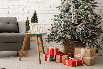 Interior of living room with Christmas tree, presents and table