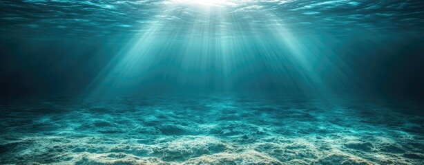 Underwater sunlight beams over sandy seabed