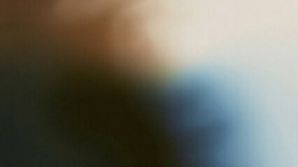 Close up abstract view of a person s shoulder and arm wearing a blue shirt