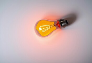 Light bulb glowing on dark and orange backgrounds symbolizing innovation and bright ideas