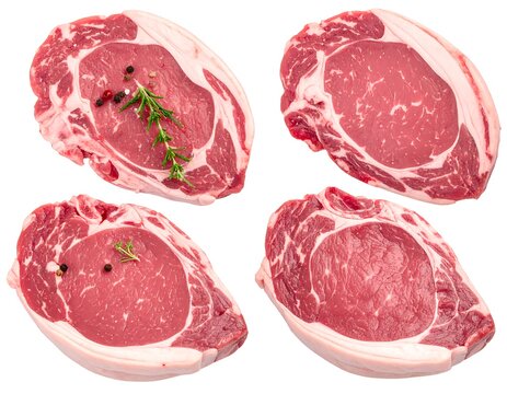 Four raw, cut pieces of red meat, ready for preparation - Powered by Adobe