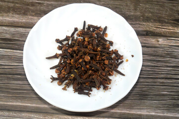 Clove, an aromatic spice derived from the dried flower buds of the Syzygium aromaticum tree, used to flavor a variety of foods, as well as in perfumes, toothpaste, and for its medicinal properties