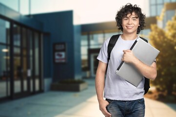 Young happy student man at university campus.