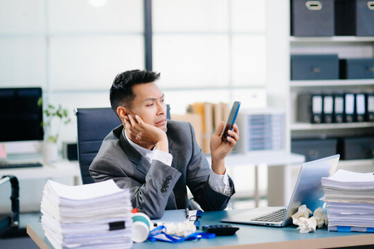 Professional office worker managing phone call and report review simultaneously, showing multitasking and corporate efficiency.