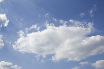 It's a sky with fluffy clouds and sunlight.