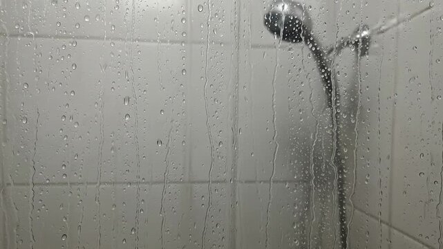 Water droplets dance on soapy shower curtain, a cleansing, refreshing abstract art