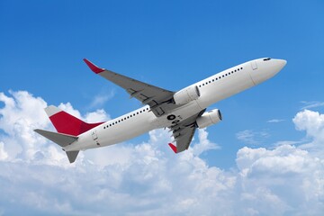 Airplane flying in blue sky with clouds, travel background