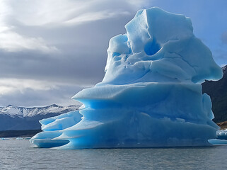 Stunning iceberg floating in the cold waters of Patagonia, Argentina, showcasing brilliant shades of blue and white in a pristine natural landscape