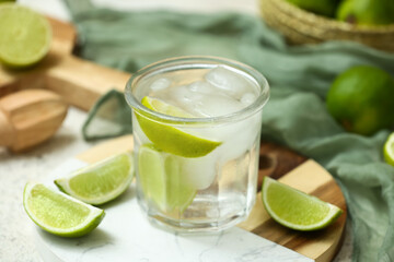 Glass of lime infused water on white background, closeup