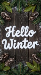 Festive winter composition with snow lettering spelling “Hello Winter” surrounded by pine cones, green fir branches, and scattered snowflakes on rustic dark wood, evoking cozy seasonal vibes
