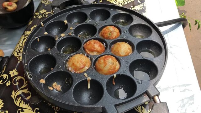 Cooking Kue Cubit, Indonesian street food, in a special pan