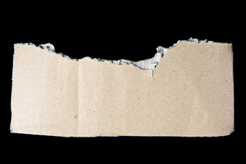 Ripped cardboard paper scraps. Piece of torn cardboard isolated on black background. damaged carton top view.  recycled cardboard.