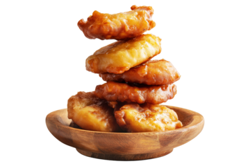 Deep-fried banana fritters either sweet or savory on wooden plate, isolated on white transparent background. Concept of Papua New Guinea cuisine.