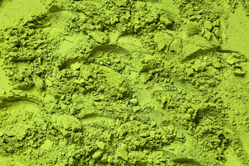 Powdered matcha tea as background, closeup