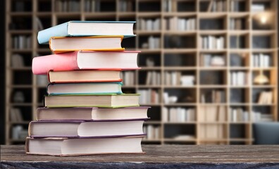 stack of reading books on desk in library