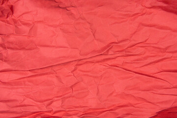 Red recycled paper texture as background, Red crumpled paper texture, Rectangular crumpled red paper sheet.