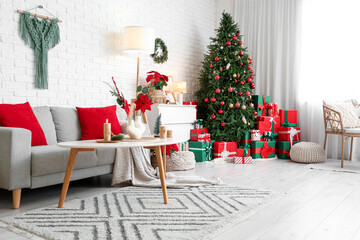 Interior of living room with Christmas flower poinsettia, sofa and presents