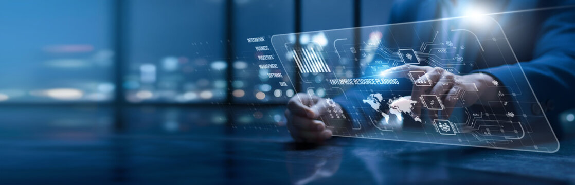 Enterprise Resource Planning. Manager using a modern interface implementing enterprise resource planning tools. Integrated systems streamline finance, operations, and supply chain processes.