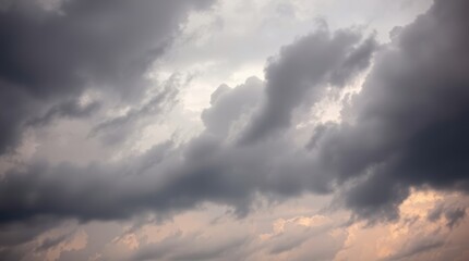 Fototapeta premium Cloudscape's Dramatic Veil: Capturing the essence of a turbulent sky, heavy clouds form a captivating tapestry. The interplay of light and shadow, creating a dynamic visual experience