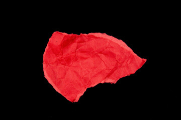 Crumpled red paper pieces isolated on black background