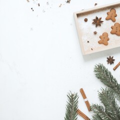 Minimal Christmas Flat Lay with Gingerbread Cookies and Pine Branches with copyspace on White Background