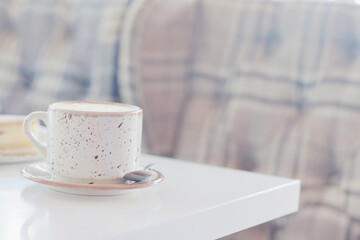 a cup of coffee in the interior of a cozy cafe for breakfast