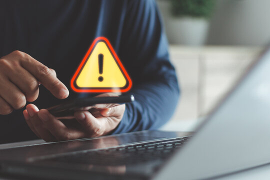 Cybersecurity alert concept showing a warning sign on a smartphone screen, symbolizing data breach, online scam or malware threat detection in digital communication and internet security systems.