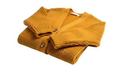 Folded knitted garment in rich mustard color isolated on black background