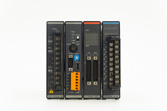 Closeup front view of a programmable logic controller with input and output modules, isolated on white background.